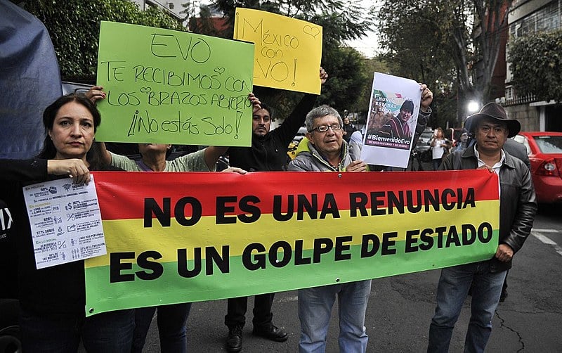 People demonstrate in support of Evo Morales, holding a banner that reads 'It's not a resignation, It's a coup', in Mexico City on Nov. 11