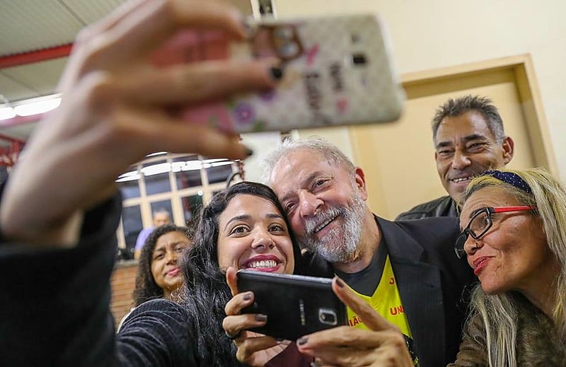 Lula foi ovacionado pelas pessoas presentes, tirou fotos e distribuiu autógrafos