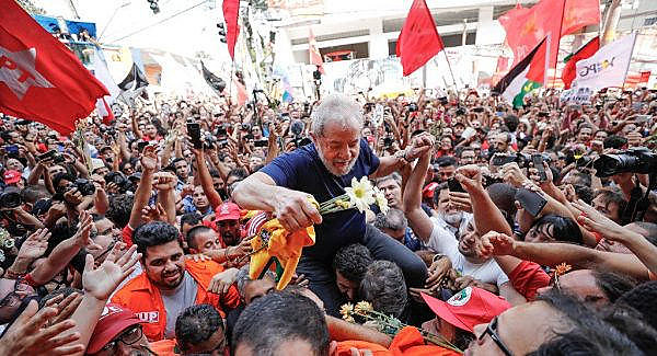 Lula is carried on the shoulders of supporters in São Bernardo do Campo before turning himself in to the Federal Police