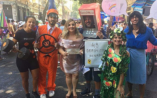 Carnival goers wear costumes alluding to scandals that implicate Bolsonaro’s administration, political party, and family
