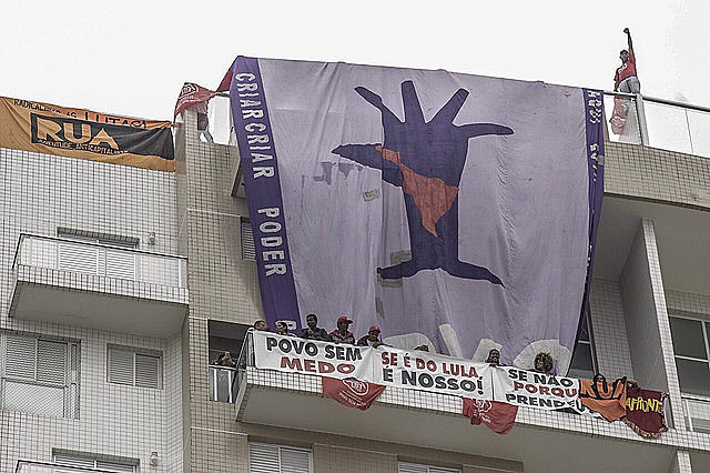 Dozens protest inside the apartment and outside the building