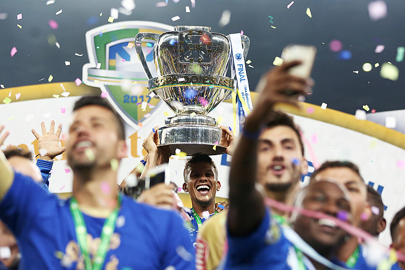 Jogadores erguem taça de pentacampeão