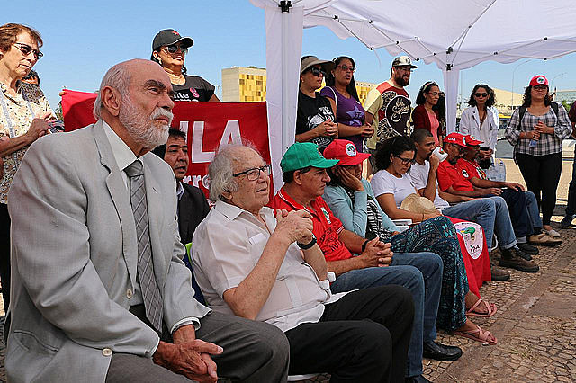 Activists take part in political rally in Brasília, surrounded by supporters