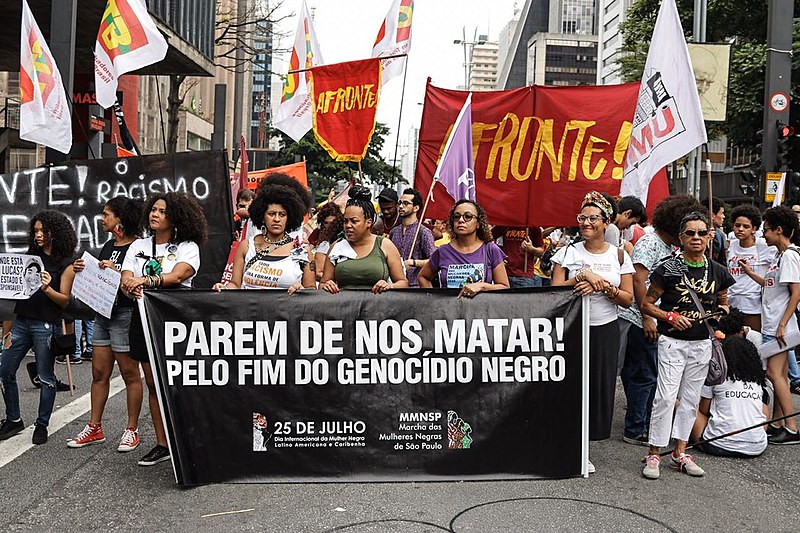 Marchers hold banner that reads "Stop killing us! For the end of black genocide" during demonstration in São Paulo on Nov. 20