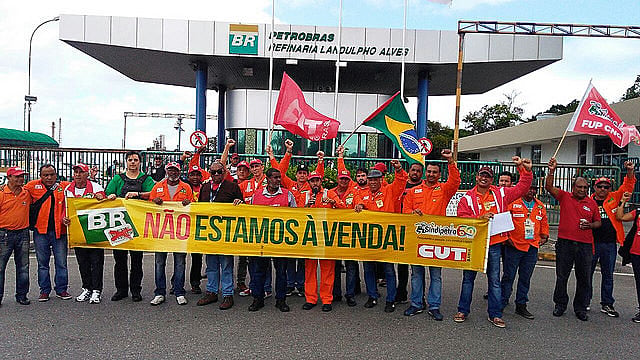 Oil workers stand against privatization of state-owned oil giant Petrobras. The banner reads “We’re not for sale”