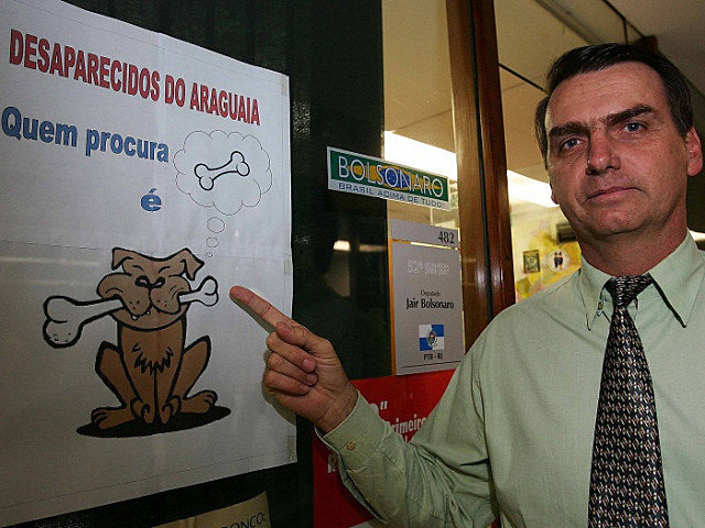 Quando era parlamentar, Bolsonaro posou ao lado de cartaz que ironizava as buscas por desaparecidos políticos da ditadura