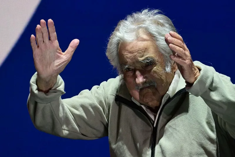 O ex-presidente uruguaio José Mujica acena para apoiadores no comício de encerramento da campanha de Yamandú Orsi, em Montevidéu