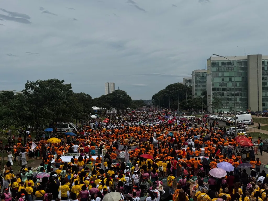 Mulheres marchando com congresso nacional no fundo