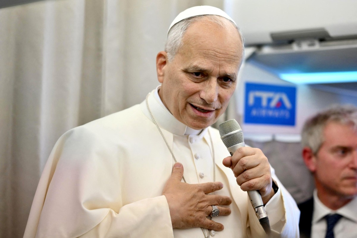 Pope Leo XIV speaks to journalists aboard a flight to Rome at the end of his apostolic journey to Turkey and Lebanon, on December 2, 2025. (Photo by Alessandro DI MEO / POOL / AFP)