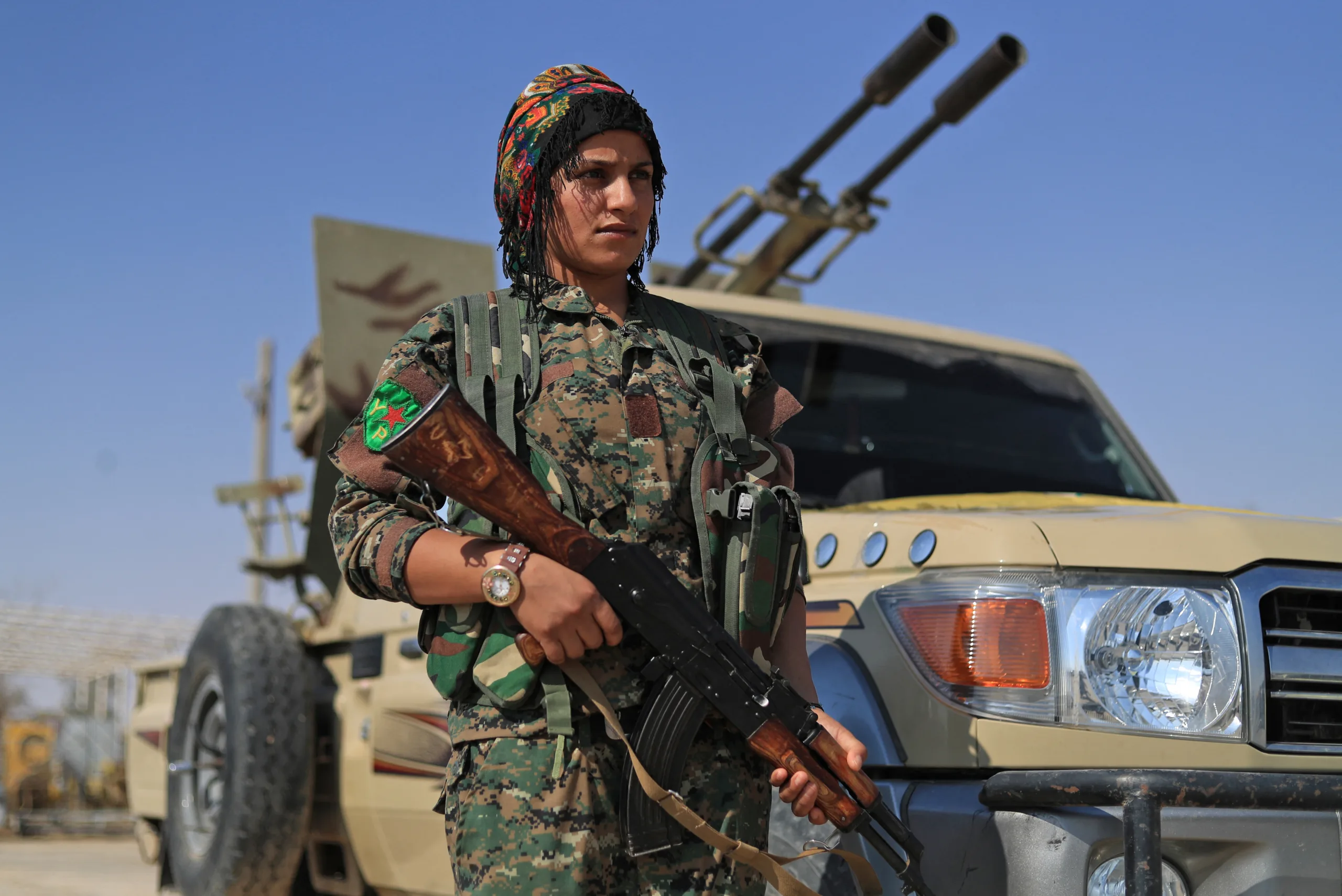 A member of the Women's Protection Units (YPJ), part of the of the Syrian Democratic Forces (SDF), lines up while gathering in the town of Shadadi, about 60 kilometres (37 miles) south of the northeastern Syrian city of Hassakeh, on September 11, 2018. The US-backed SDF, an alliance of Kurdish and Arab fighters, launched on September 10 an assault against a dwindling pocket of territory held by the Islamic State group in the town of Hajin in eastern Syria near the border with Iraq. (Photo by Delil SOULEIMAN / AFP)