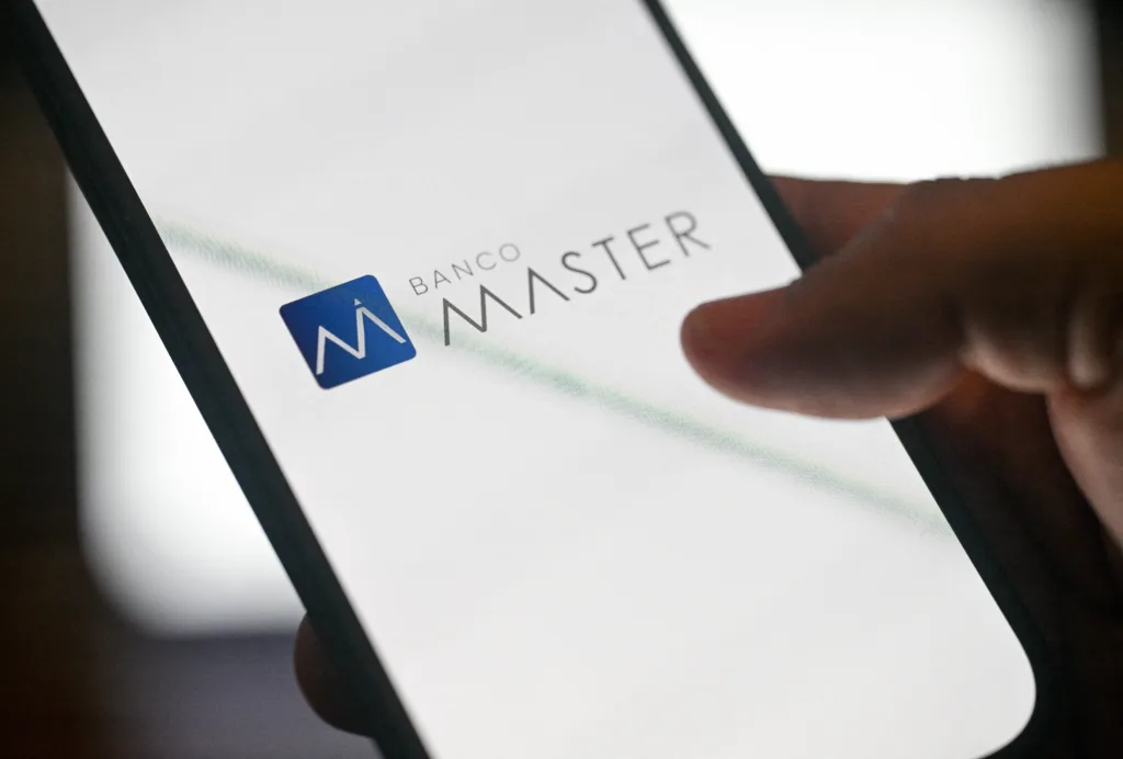 In this photo illustration, the logo of Brazilian bank Banco Master is displayed on a smartphone in Rio de Janeiro, Brazil, on March 4, 2026. Brazilian police arrested businessman Daniel Vorcaro at the heart of a major bank scandal on March 4, 2026, that has rattled the highest echelons of power in Latin America's largest economy. (Photo by MAURO PIMENTEL / AFP)