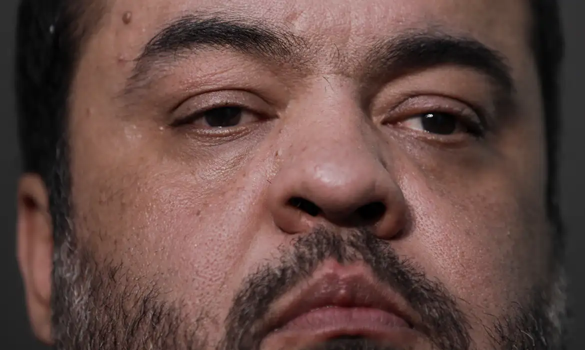 Foto do rosto de Cláudio Castro. Homem branco, cabelos pretos e barba aparada