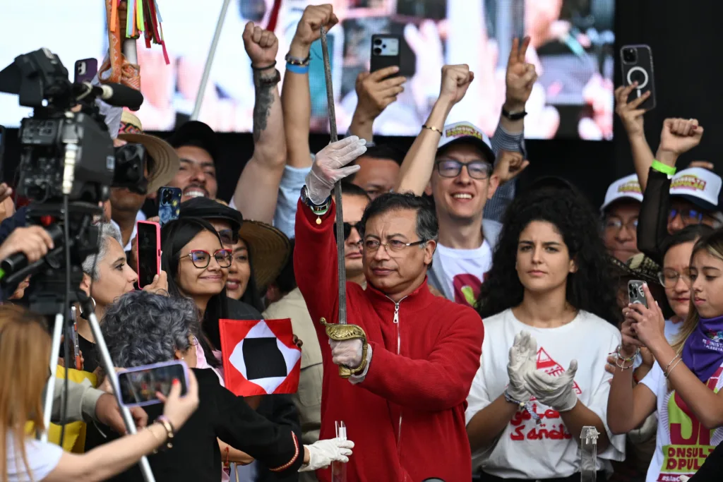 Colombia's President Gustavo Petro holds the sword of Liberator Simon Bolivar during a May Day (Labour Day) rally, marking International Workers' Day, and in defence of his government reforms in Bogota on May 1, 2025. (Photo by Raul ARBOLEDA / AFP)