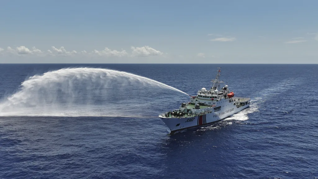 Navio Chuanshan da Guarda Costeira da China realiza um disparo de advertência com canhão de água durante um treinamento nas águas territoriais de Huangyan Dao, na China, no Mar da China Meridional.